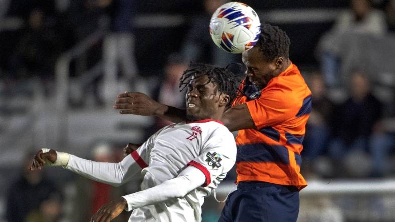 Dec 12, 2022; Cary, NC, USA; Syracuse defender Abdi Salim (3) heads the ball over Indiana forward Herbert Endeley (17) in the first half at WakeMed Soccer Park. Mandatory Credit: Bob Donnan-USA TODAY Sports