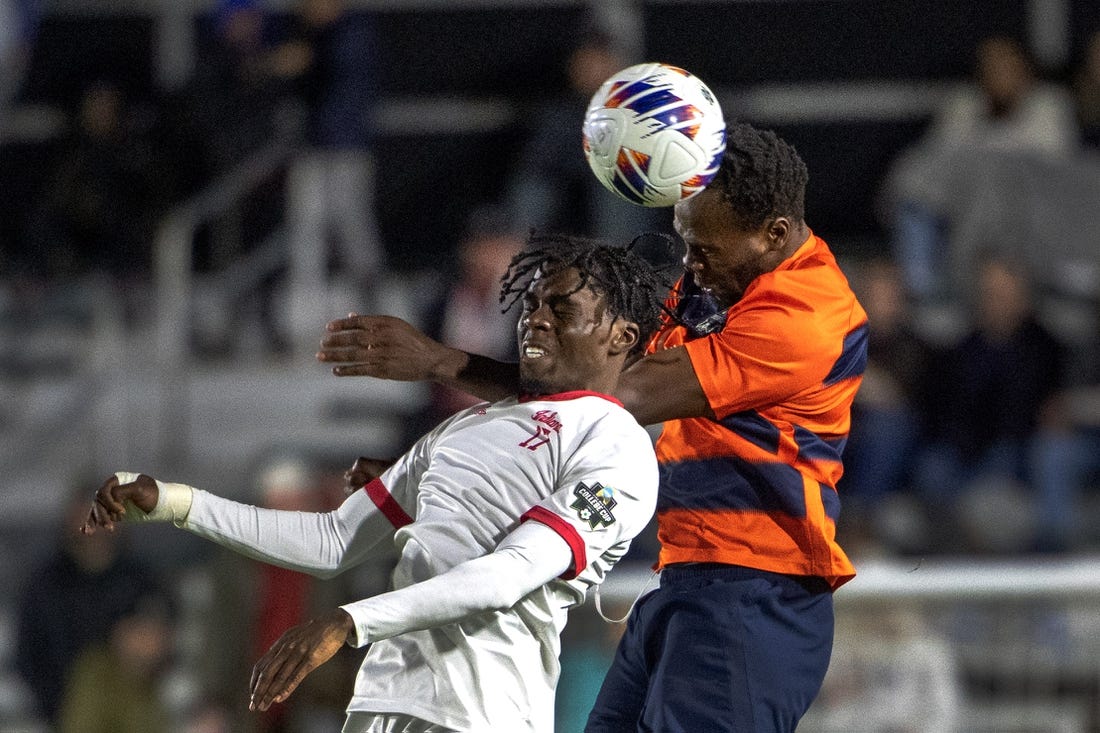 Dec 12, 2022; Cary, NC, USA; Syracuse defender Abdi Salim (3) heads the ball over Indiana forward Herbert Endeley (17) in the first half at WakeMed Soccer Park. Mandatory Credit: Bob Donnan-USA TODAY Sports