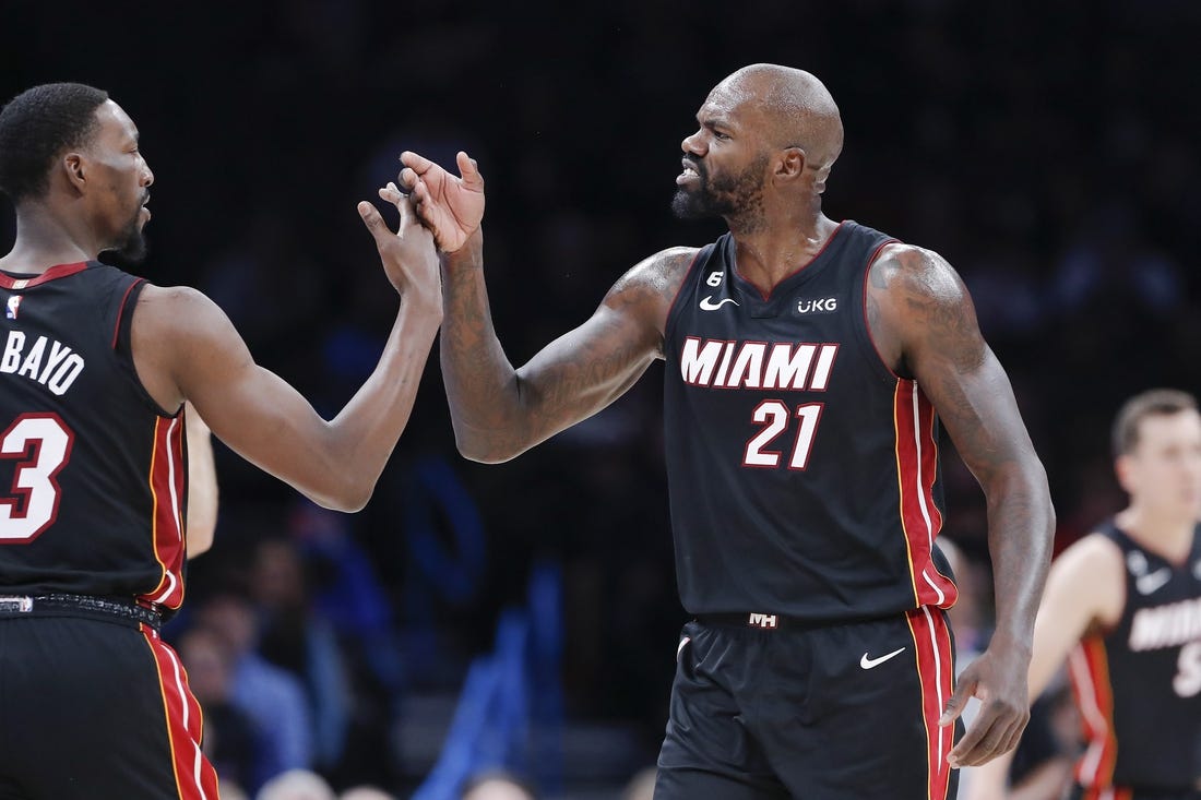 Dec 14, 2022; Oklahoma City, Oklahoma, USA; Miami Heat center Dewayne Dedmon (21) high fives center Bam Adebayo (13) between plays against the Oklahoma City Thunder during the second quarter at Paycom Center. Mandatory Credit: Alonzo Adams-USA TODAY Sports