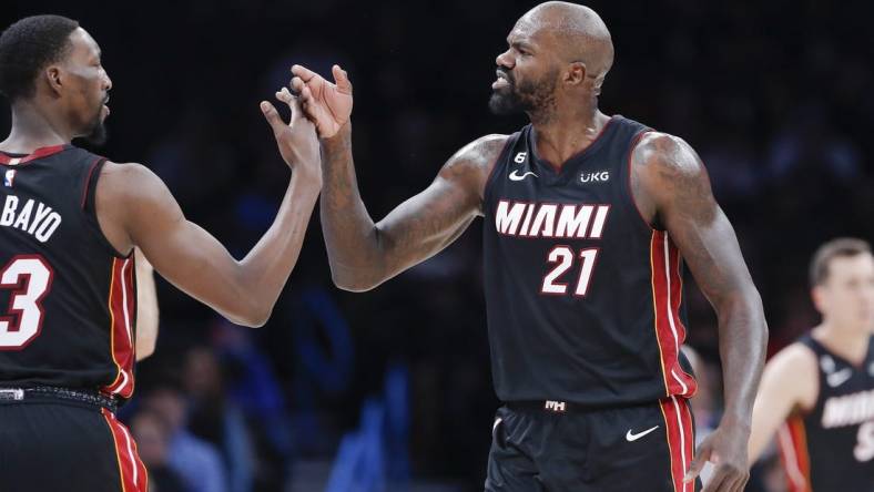 Dec 14, 2022; Oklahoma City, Oklahoma, USA; Miami Heat center Dewayne Dedmon (21) high fives center Bam Adebayo (13) between plays against the Oklahoma City Thunder during the second quarter at Paycom Center. Mandatory Credit: Alonzo Adams-USA TODAY Sports