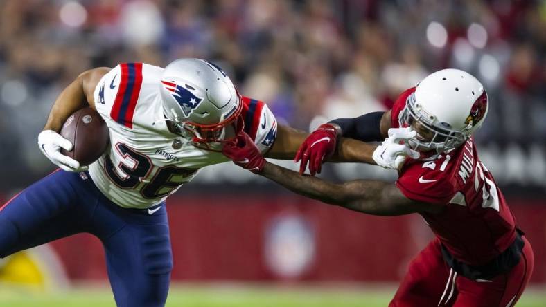 Dec 12, 2022; Glendale, Arizona, USA; New England Patriots running back Kevin Harris (36) is face masked by Arizona Cardinals cornerback Trayvon Mullen (21) in the first half at State Farm Stadium. Mandatory Credit: Mark J. Rebilas-USA TODAY Sports