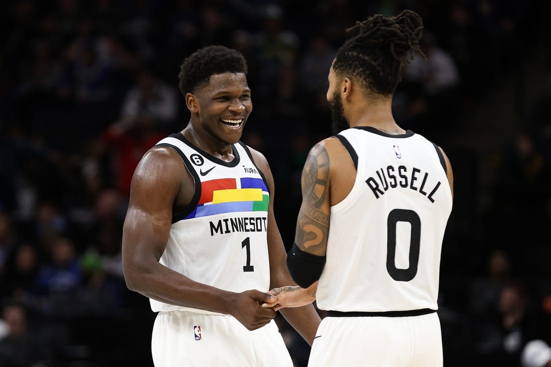 Dec 18, 2022; Minneapolis, Minnesota, USA; Minnesota Timberwolves guard Anthony Edwards (1) and guard D'Angelo Russell (0) celebrate during the third quarter against the Chicago Bulls at Target Center. Mandatory Credit: Matt Krohn-USA TODAY Sports