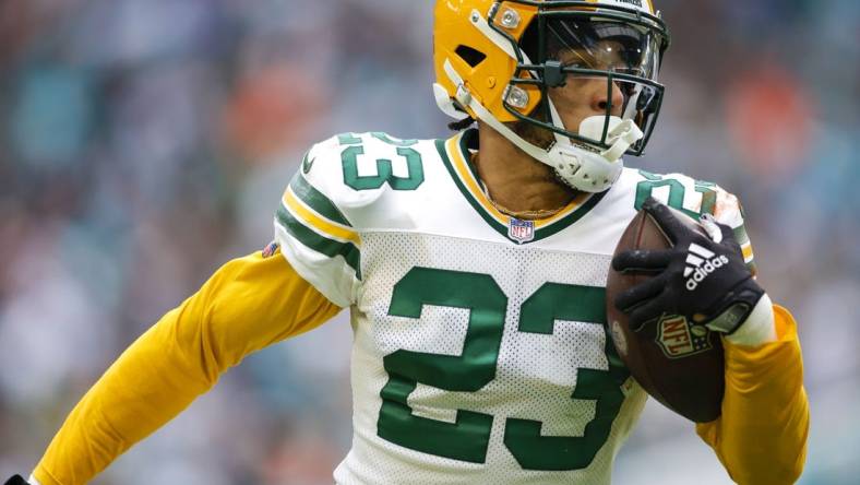 Dec 25, 2022; Miami Gardens, Florida, USA; Green Bay Packers cornerback Jaire Alexander (23) runs with the football after intercepting a pass during the fourth quarter against the Miami Dolphins at Hard Rock Stadium. Mandatory Credit: Sam Navarro-USA TODAY Sports