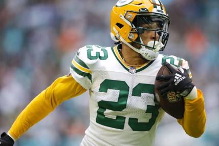 Dec 25, 2022; Miami Gardens, Florida, USA; Green Bay Packers cornerback Jaire Alexander (23) runs with the football after intercepting a pass during the fourth quarter against the Miami Dolphins at Hard Rock Stadium. Mandatory Credit: Sam Navarro-USA TODAY Sports