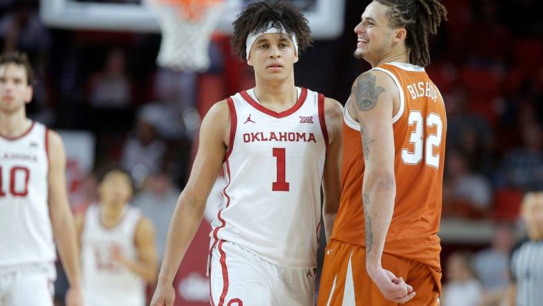 Texas Longhorns forward Christian Bishop (32) smiles as he walks past Oklahoma Sooners forward Jalen Hill (1) during an NCAA men's college basketball game between the University of Oklahoma and Texas at Lloyd Noble Center in Norman, Okla., Saturday, Dec. 31, 2022. Texas won 70-69.

Oklahoma Vs Texas Basketball