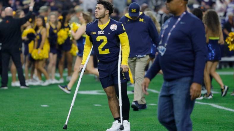 Michigan running back Blake Corum (2) is seen on the field on crutches before the start of the Fiesta Bowl against TCU on Saturday, Dec. 31 at State Farm Stadium in Glendale, Ariz.

H3 3755