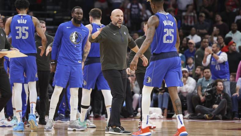 Jan 2, 2023; Houston, Texas, USA; Dallas Mavericks head coach Jason Kidd celebrates with forward Reggie Bullock (25) after a play during the fourth quarter against the Houston Rockets at Toyota Center. Mandatory Credit: Troy Taormina-USA TODAY Sports