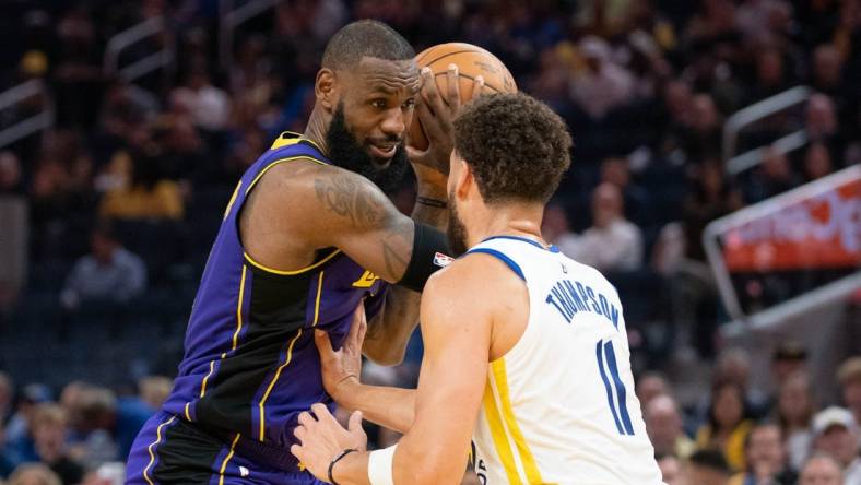 October 18, 2022; San Francisco, California, USA; Los Angeles Lakers forward LeBron James (6) controls the basketball against Golden State Warriors guard Klay Thompson (11) during the third quarter at Chase Center. Mandatory Credit: Kyle Terada-USA TODAY Sports
