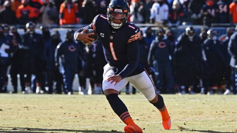 Dec 24, 2022; Chicago, Illinois, USA;  Chicago Bears quarterback Justin Fields (1) runs with the ball against the Buffalo Bills at Soldier Field. Mandatory Credit: Jamie Sabau-USA TODAY Sports