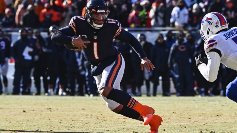 Dec 24, 2022; Chicago, Illinois, USA;  Chicago Bears quarterback Justin Fields (1) runs with the ball against the Buffalo Bills at Soldier Field. Mandatory Credit: Jamie Sabau-USA TODAY Sports