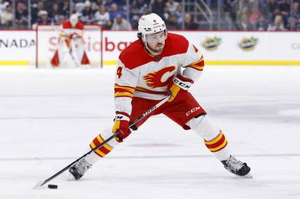 Jan 3, 2023; Winnipeg, Manitoba, CAN;  Calgary Flames defenseman Rasmus Andersson (4) skates with the puck in the first period against the Winnipeg Jets at Canada Life Centre. Mandatory Credit: James Carey Lauder-USA TODAY Sports