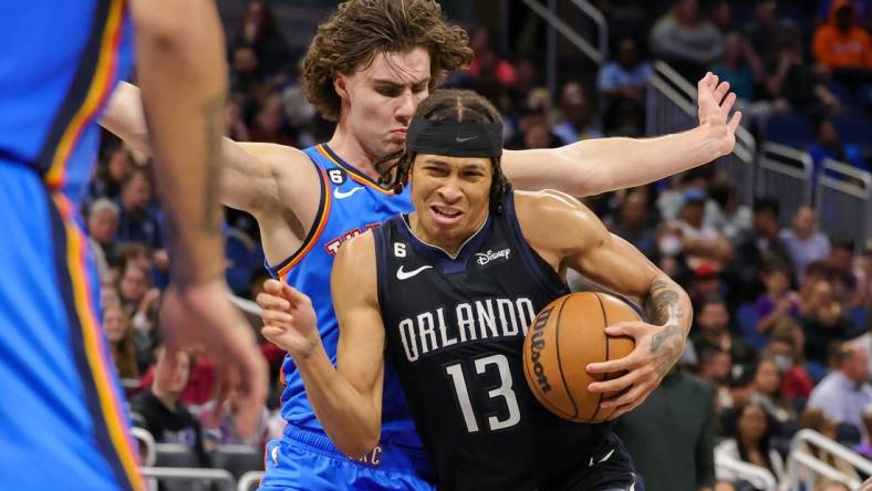 Jan 4, 2023; Orlando, Florida, USA; Orlando Magic guard R.J. Hampton (13) is fouled by Oklahoma City Thunder guard Josh Giddey (3) during the second half at Amway Center. Mandatory Credit: Mike Watters-USA TODAY Sports