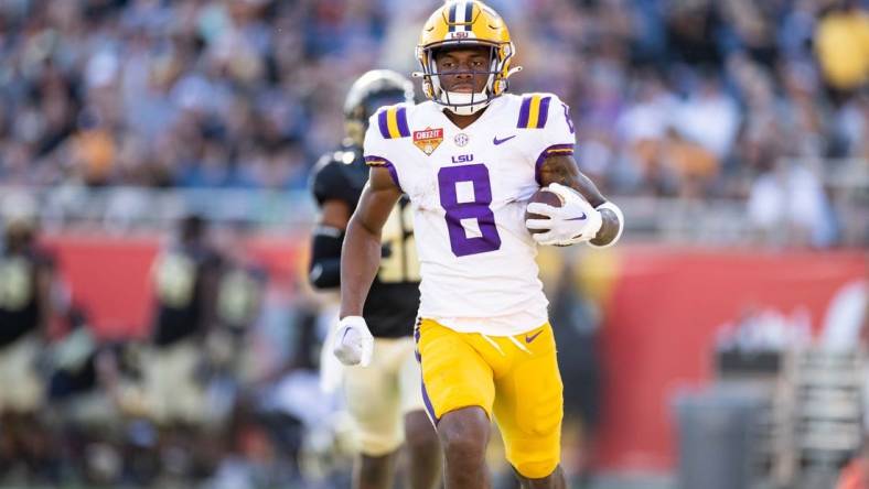 Jan 2, 2023; Orlando, FL, USA; LSU Tigers wide receiver Malik Nabers (8) rushes with the ball for a touchdown during the second half against the Purdue Boilermakers at Camping World Stadium. Mandatory Credit: Matt Pendleton-USA TODAY Sports