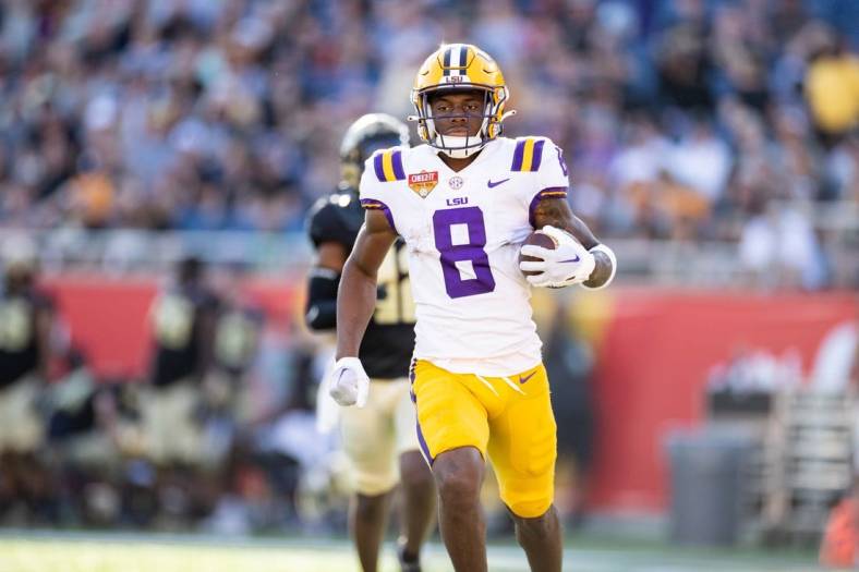 Jan 2, 2023; Orlando, FL, USA; LSU Tigers wide receiver Malik Nabers (8) rushes with the ball for a touchdown during the second half against the Purdue Boilermakers at Camping World Stadium. Mandatory Credit: Matt Pendleton-USA TODAY Sports