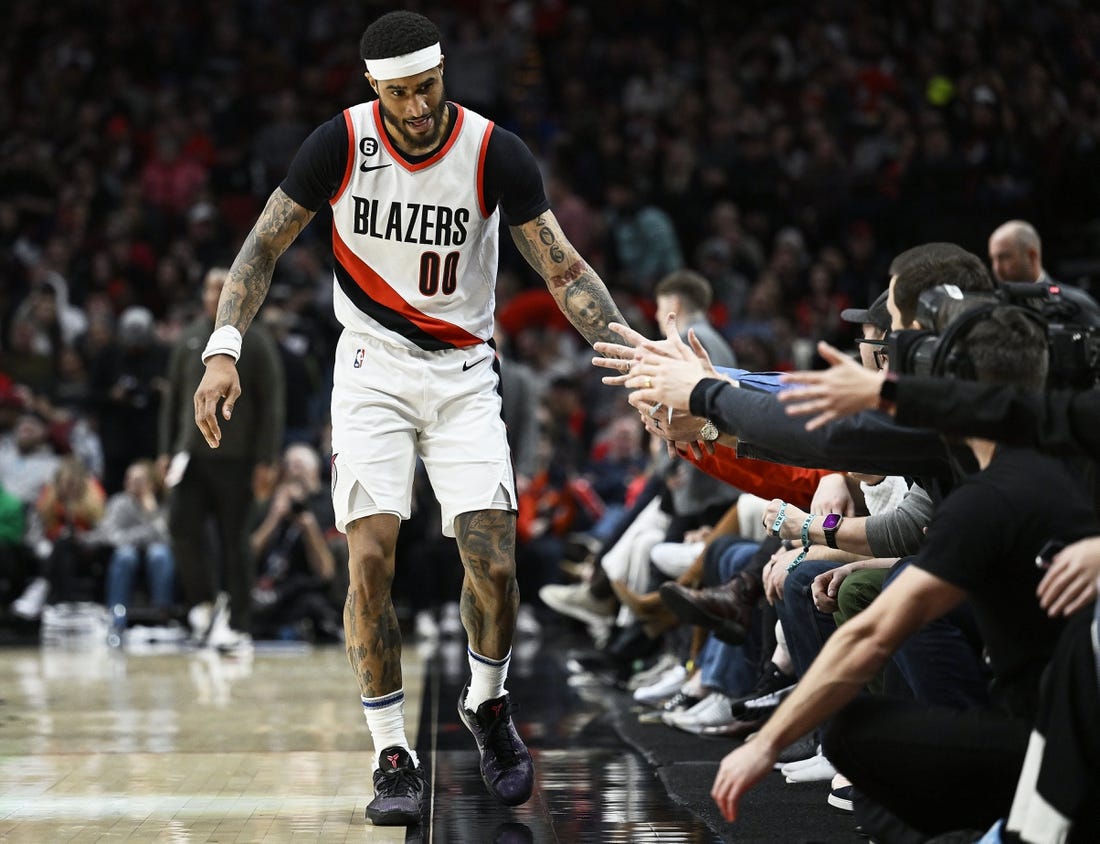 Jan 14, 2023; Portland, Oregon, USA; Portland Trail Blazers guard Gary Payton II (00) gives fans high-fives during the first half against the Dallas Mavericks at Moda Center. Mandatory Credit: Troy Wayrynen-USA TODAY Sports