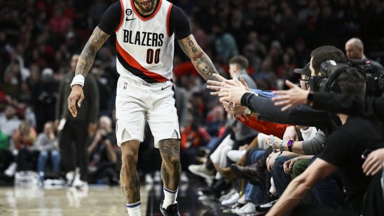 Jan 14, 2023; Portland, Oregon, USA; Portland Trail Blazers guard Gary Payton II (00) gives fans high-fives during the first half against the Dallas Mavericks at Moda Center. Mandatory Credit: Troy Wayrynen-USA TODAY Sports