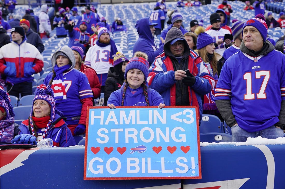 Jan 15, 2023; Orchard Park, NY, USA; Buffalo Bills fans cheer and hold a sign in support of safety Damar Hamlin (not pictured) before a NFL wild card game against the Miami Dolphins at Highmark Stadium. Mandatory Credit: Gregory Fisher-USA TODAY Sports