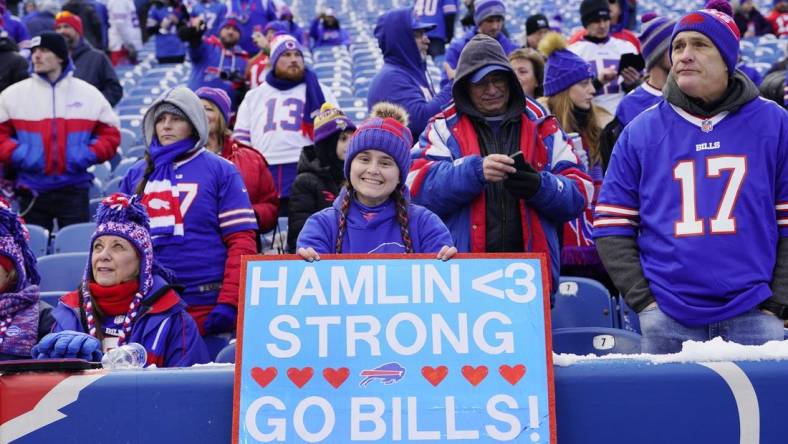 Jan 15, 2023; Orchard Park, NY, USA; Buffalo Bills fans cheer and hold a sign in support of safety Damar Hamlin (not pictured) before a NFL wild card game against the Miami Dolphins at Highmark Stadium. Mandatory Credit: Gregory Fisher-USA TODAY Sports