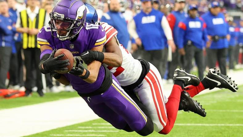 Jan 15, 2023; Minneapolis, Minnesota, USA; Minnesota Vikings wide receiver Justin Jefferson (18) dives for the end zone as New York Giants cornerback Adoree' Jackson (22) defends during the first quarter of a wild card game at U.S. Bank Stadium. The call on the field was a touchdown but was changed after review. Mandatory Credit: Matt Krohn-USA TODAY Sports