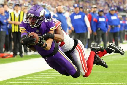 Jan 15, 2023; Minneapolis, Minnesota, USA; Minnesota Vikings wide receiver Justin Jefferson (18) dives for the end zone as New York Giants cornerback Adoree' Jackson (22) defends during the first quarter of a wild card game at U.S. Bank Stadium. The call on the field was a touchdown but was changed after review. Mandatory Credit: Matt Krohn-USA TODAY Sports