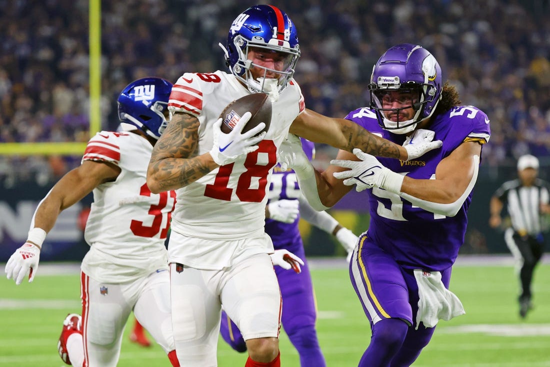 Jan 15, 2023; Minneapolis, Minnesota, USA; New York Giants wide receiver Isaiah Hodgins (18) runs with the ball against Minnesota Vikings linebacker Eric Kendricks (54) during the third quarter of a wild card game at U.S. Bank Stadium. Mandatory Credit: Matt Krohn-USA TODAY Sports