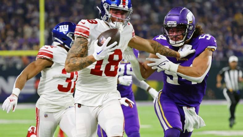 Jan 15, 2023; Minneapolis, Minnesota, USA; New York Giants wide receiver Isaiah Hodgins (18) runs with the ball against Minnesota Vikings linebacker Eric Kendricks (54) during the third quarter of a wild card game at U.S. Bank Stadium. Mandatory Credit: Matt Krohn-USA TODAY Sports