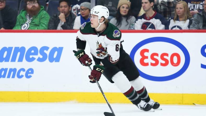 Jan 15, 2023; Winnipeg, Manitoba, CAN;  Arizona Coyotes defenseman Jakob Chychrun (6) looks to make a pass against the Winnipeg Jets during the second period at Canada Life Centre. Mandatory Credit: Terrence Lee-USA TODAY Sports