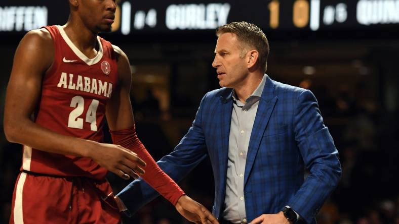 Jan 17, 2023; Nashville, Tennessee, USA; Alabama Crimson Tide head coach Nate Oats slaps hands with forward Brandon Miller (24) as he leaves the game during the first half against the Vanderbilt Commodores at Memorial Gymnasium. Mandatory Credit: Christopher Hanewinckel-USA TODAY Sports