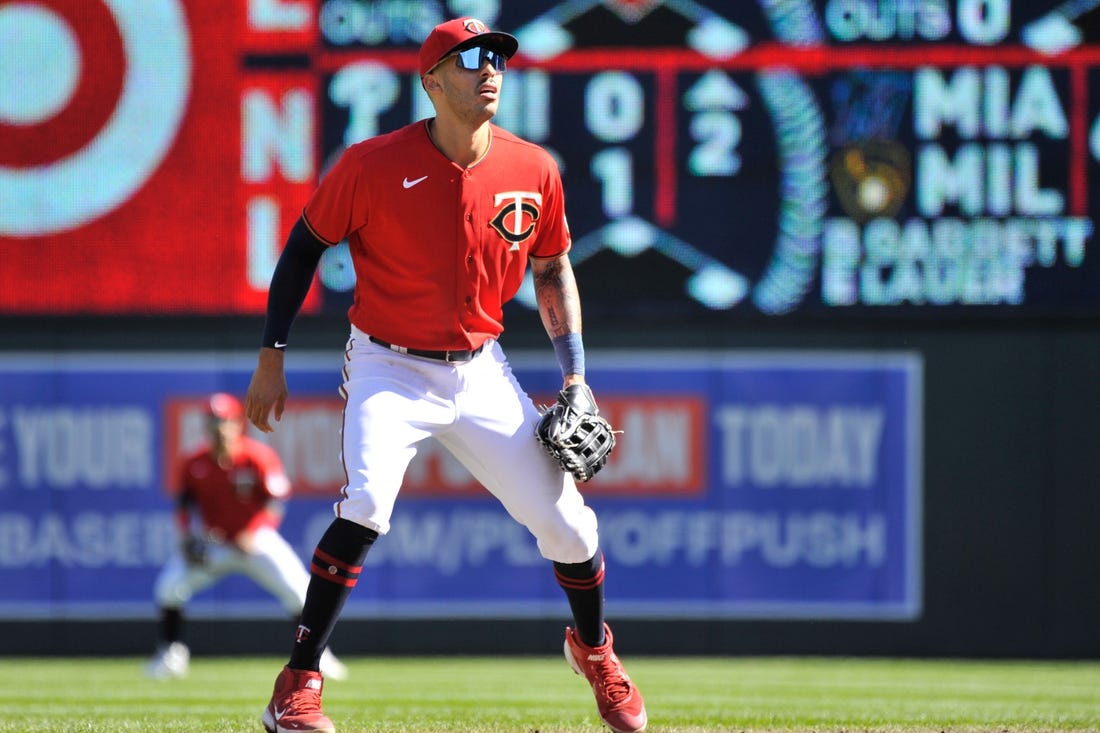 Minnesota Twins' Carlos Correa and Daniella Correa await the