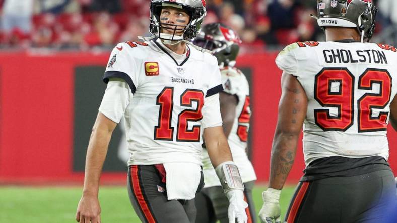 Jan 16, 2023; Tampa, Florida, USA; Tampa Bay Buccaneers quarterback Tom Brady (12) walks off the field in the final minute against the Dallas Cowboys in the fourth quarter during a wild card game at Raymond James Stadium. Mandatory Credit: Nathan Ray Seebeck-USA TODAY Sports