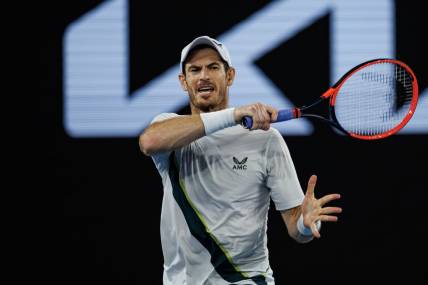 Jan 21, 2023; Melbourne, Victoria, Australia;   Andy Murray of Great Britain hits a forehand against Roberto Bautista-Agut of Spain on day six of the 2023 Australian Open tennis tournament at Melbourne Park. Mandatory Credit: Mike Frey-USA TODAY Sports