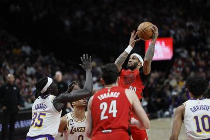 Jan 22, 2023; Portland, Oregon, USA; Portland Trail Blazers shooting guard Gary Payton II (00) shoots the ball over Los Angeles Lakers point guard Russell Westbrook (0) and forward Wenyen Gabriel (35) during the second half at Moda Center. Mandatory Credit: Soobum Im-USA TODAY Sports