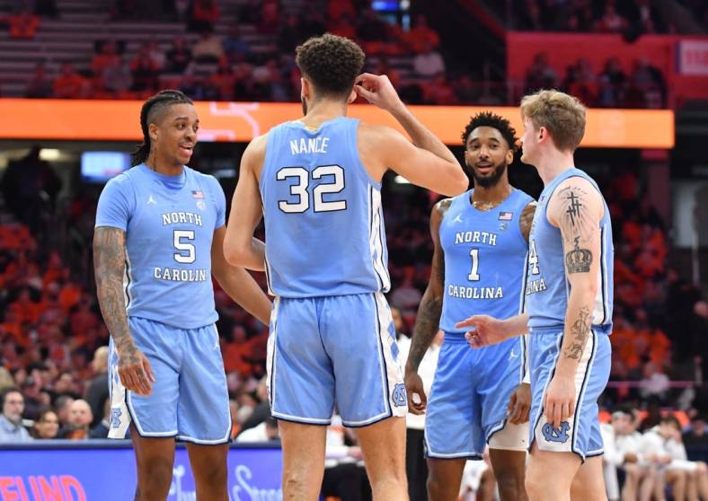 Jan 24, 2023; Syracuse, New York, USA; North Carolina Tar Heels players Armando Bacot (5) and Pete Nance (32) and Leaky Black (1) and Tyler Nickel (24) have a discussion during a timeout in the second half game against the Syracuse Orange at JMA Wireless Dome. Mandatory Credit: Mark Konezny-USA TODAY Sports