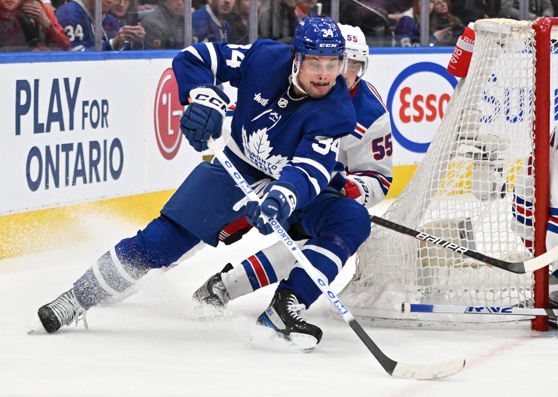 Jan 25, 2023; Toronto, Ontario, CAN;   Toronto Maple Leafs forward Auston Matthews (34) skates with the puck as New York Rangers defenseman Ryan Lindgren (55) defends in the third period at Scotiabank Arena. Mandatory Credit: Dan Hamilton-USA TODAY Sports