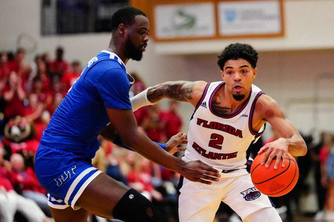 Jan 26, 2023; Boca Raton, Florida, USA; Florida Atlantic Owls guard Nicholas Boyd (2) dribbles past Middle Tennessee Blue Raiders guard Camryn Weston (24) during the second half at Eleanor R. Baldwin Arena. Mandatory Credit: Rich Storry-USA TODAY Sports