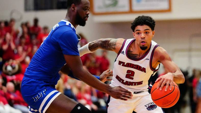 Jan 26, 2023; Boca Raton, Florida, USA; Florida Atlantic Owls guard Nicholas Boyd (2) dribbles past Middle Tennessee Blue Raiders guard Camryn Weston (24) during the second half at Eleanor R. Baldwin Arena. Mandatory Credit: Rich Storry-USA TODAY Sports