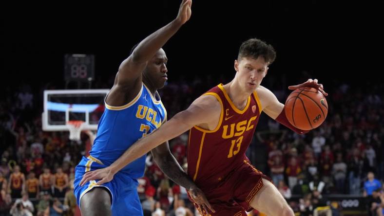 Jan 26, 2023; Los Angeles, California, USA; Southern California Trojans guard Drew Peterson (13) dribbles the ball against UCLA Bruins guard David Singleton (34) in the second half at Galen Center. Mandatory Credit: Kirby Lee-USA TODAY Sports