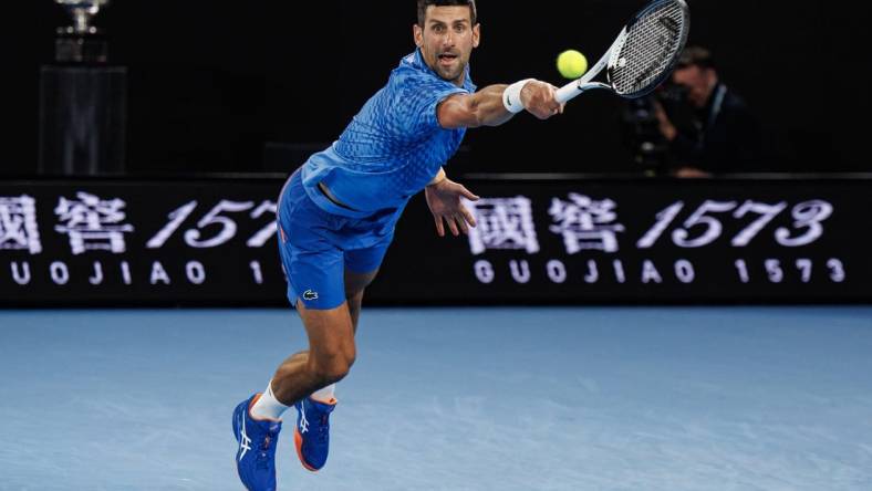 Jan 29, 2023; Melbourne, Victoria, Australia; Novak Djokovic of Serbia hits a shot against Stefanos Tsitsipas of Greece at the men's final on day fourteen of the 2023 Australian Open tennis tournament at Melbourne Park. Mandatory Credit: Mike Frey-USA TODAY Sports