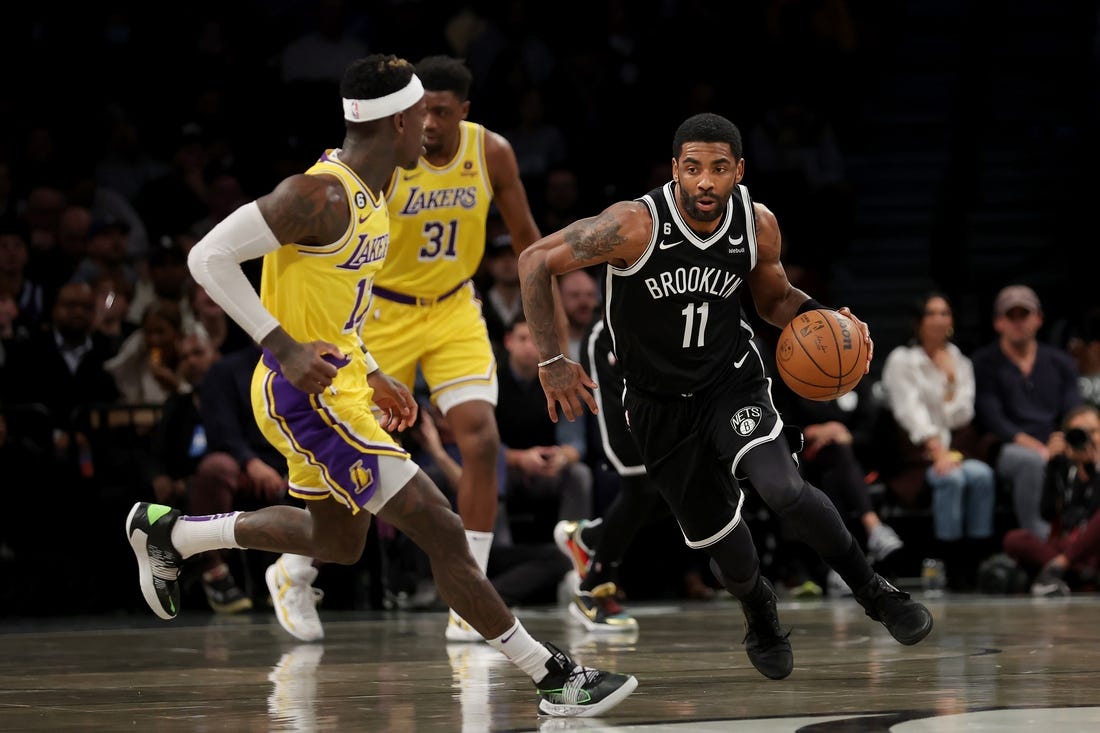 Jan 30, 2023; Brooklyn, New York, USA; Brooklyn Nets guard Kyrie Irving (11) brings the ball up court against Los Angeles Lakers guard Dennis Schroder (17) during the first quarter at Barclays Center. Mandatory Credit: Brad Penner-USA TODAY Sports