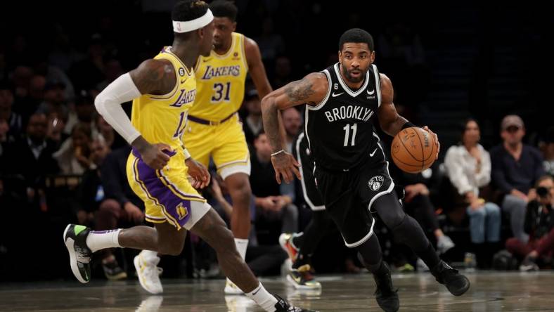 Jan 30, 2023; Brooklyn, New York, USA; Brooklyn Nets guard Kyrie Irving (11) brings the ball up court against Los Angeles Lakers guard Dennis Schroder (17) during the first quarter at Barclays Center. Mandatory Credit: Brad Penner-USA TODAY Sports