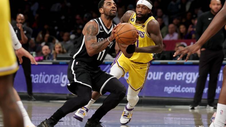 Jan 30, 2023; Brooklyn, New York, USA; Brooklyn Nets guard Kyrie Irving (11) takes a shot against Los Angeles Lakers guard Patrick Beverley (21) during the first quarter at Barclays Center. Mandatory Credit: Brad Penner-USA TODAY Sports