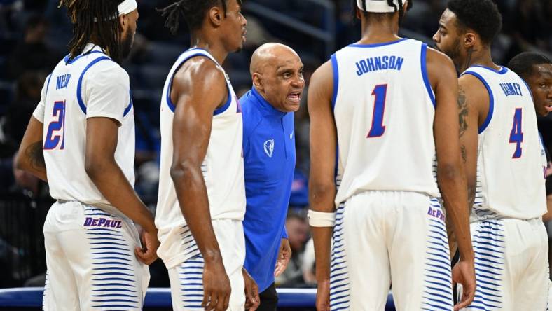 Jan 31, 2023; Chicago, Illinois, USA; DePaul Blue Demons head coach Tony Stubblefield (center) talks to forward Da'Sean Nelson (21), forward Eral Penn (11), forward Javan Johnson (1) and guard K.T. Raimey (4) during a timeout in the first half against the Connecticut Huskies at Wintrust Arena. Mandatory Credit: Jamie Sabau-USA TODAY Sports