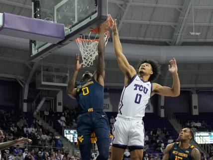Jan 31, 2023; Fort Worth, Texas, USA; West Virginia Mountaineers guard Kedrian Johnson (0) has his shot blocked by TCU Horned Frogs guard Micah Peavy (0) during the second half at Ed and Rae Schollmaier Arena. Mandatory Credit: Chris Jones-USA TODAY Sports