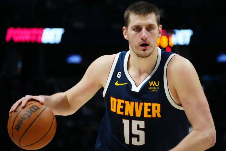Jan 31, 2023; Denver, Colorado, USA; Denver Nuggets center Nikola Jokic (15) dribbles the ball in the second half against the New Orleans Pelicans at Ball Arena. Mandatory Credit: Ron Chenoy-USA TODAY Sports