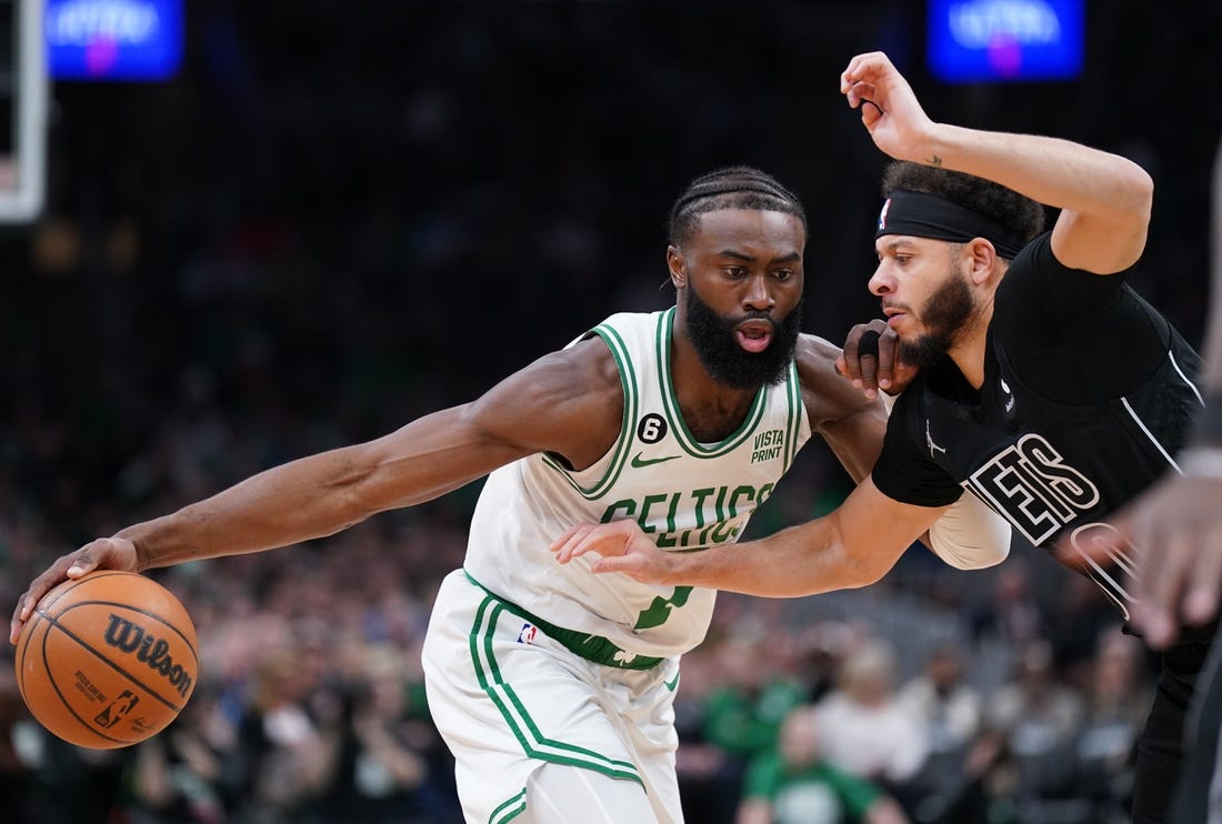 Feb 1, 2023; Boston, Massachusetts, USA; Boston Celtics guard Jaylen Brown (7) drives the ball against Brooklyn Nets guard Seth Curry (30) in the first quarter at TD Garden. Mandatory Credit: David Butler II-USA TODAY Sports