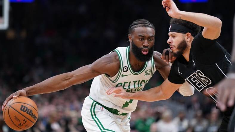 Feb 1, 2023; Boston, Massachusetts, USA; Boston Celtics guard Jaylen Brown (7) drives the ball against Brooklyn Nets guard Seth Curry (30) in the first quarter at TD Garden. Mandatory Credit: David Butler II-USA TODAY Sports