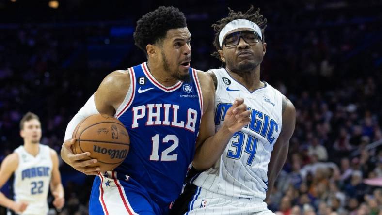 Feb 1, 2023; Philadelphia, Pennsylvania, USA; Philadelphia 76ers forward Tobias Harris (12) drives with the ball against Orlando Magic center Wendell Carter Jr. (34) during the third quarter at Wells Fargo Center. Mandatory Credit: Bill Streicher-USA TODAY Sports