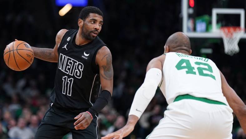 Feb 1, 2023; Boston, Massachusetts, USA; Brooklyn Nets guard Kyrie Irving (11) returns the ball against Boston Celtics center Al Horford (42) in the second half at TD Garden. Mandatory Credit: David Butler II-USA TODAY Sports