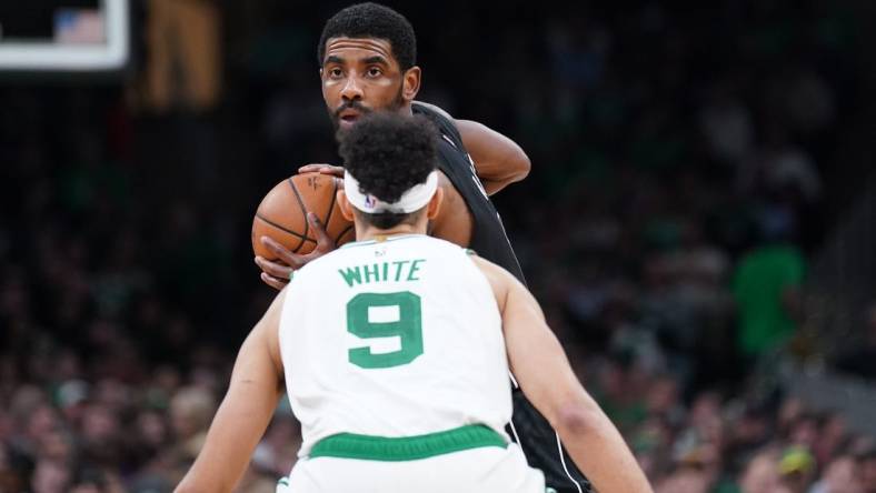 Feb 1, 2023; Boston, Massachusetts, USA; Brooklyn Nets guard Kyrie Irving (11) looks for an opening against Boston Celtics guard Derrick White (9) in the second half at TD Garden. Mandatory Credit: David Butler II-USA TODAY Sports