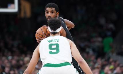 Feb 1, 2023; Boston, Massachusetts, USA; Brooklyn Nets guard Kyrie Irving (11) looks for an opening against Boston Celtics guard Derrick White (9) in the second half at TD Garden. Mandatory Credit: David Butler II-USA TODAY Sports